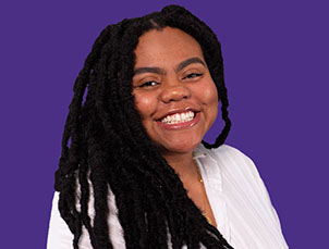 A photo of Erin Lee, smiling against a flat purple background.