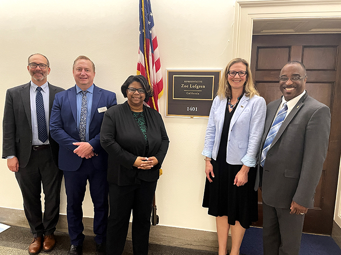 Phil Trella, Chris Nelson, Amy Scott, Amanda Godley, and Clay Gloster stand in front of Representative Zoe Lofgren's (D-CA) office before a meeting with her staff member.